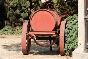 Old agricultural machinery stands on the street in Israel and rusts photo