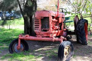 Old agricultural machinery stands on the street in Israel and rusts photo