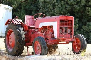 Old agricultural machinery stands on the street in Israel and rusts photo