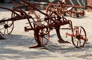 Old agricultural machinery stands on the street in Israel and rusts photo