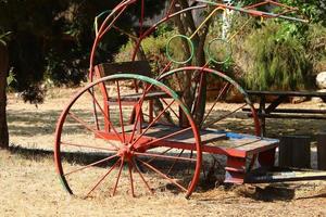 Old agricultural machinery stands on the street in Israel and rusts photo