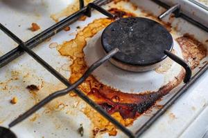 Dirty stove with food leftovers photo