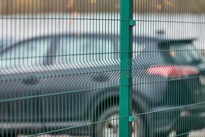 Fenced car parking lot with security photo