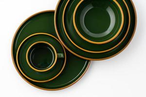 A set of dark green ceramic tableware with orange outlines on a white background photo