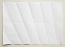 White folded and wrinkled paper on white background photo