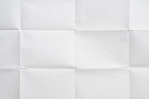 White folded and wrinkled paper texture background photo