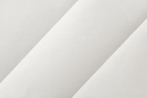 White folded and wrinkled paper texture background photo
