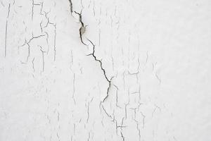 cracked concrete on white wall texture background photo