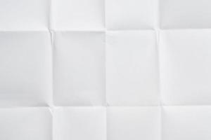 White folded and wrinkled paper texture background photo