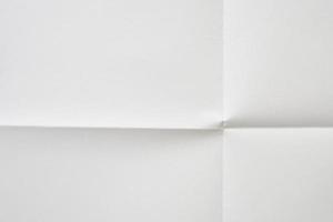 White folded and wrinkled paper texture background photo