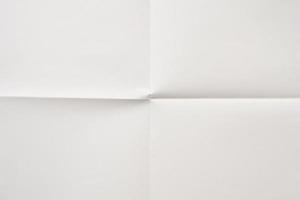 White folded and wrinkled paper texture background photo