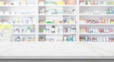 Empty white marble counter top with blur pharmacy drugstore shelves background photo