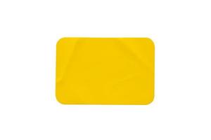 Yellow plastic sticker label isolated on white background photo