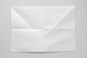 White folded and wrinkled paper on white background photo