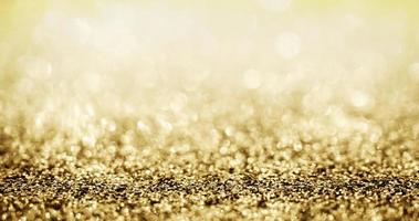 Abstract gold glitter sparkle with bokeh background photo