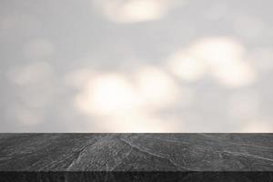 Marble table top with tree shadow drop on white wall background for mockup product display photo