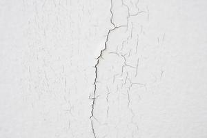 hormigón agrietado sobre fondo de textura de pared blanca foto