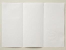 White folded and wrinkled paper on white background photo