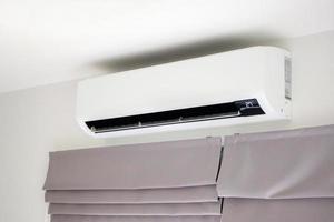 Air conditioner on white wall room interior background photo