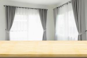 Empty wood table top with blur room interior with window curtain background photo