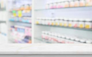 Empty white marble counter top with blur pharmacy drugstore shelves background photo