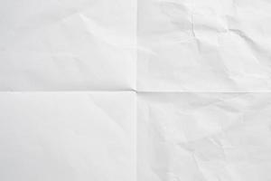 White folded and wrinkled paper texture background photo