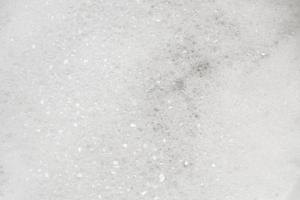 Fondo de textura de espuma de jabón blanco abstracto de cerca foto