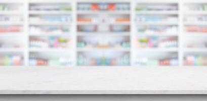 Empty white marble counter top with blur pharmacy drugstore shelves background photo