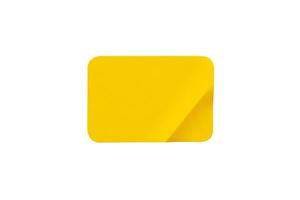 Yellow plastic sticker label isolated on white background photo