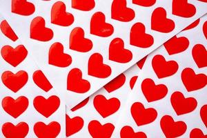 Close up red heart sticker on white paper photo