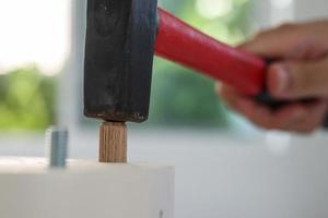 Man assembling furniture at home photo