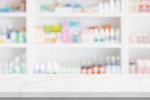 Empty white marble counter top with blur pharmacy drugstore shelves background photo