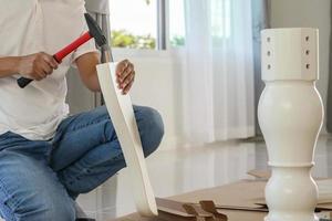 Man assembling furniture at home photo