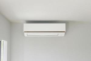 Air conditioner on white wall room interior background photo