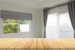 Empty wood table top with blur room interior with window curtain background photo