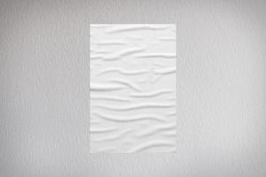 Blank white wheatpaste glued paper poster mockup on concrete wall background photo