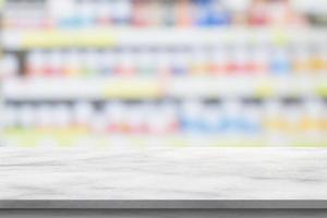 Empty white marble counter top with blur pharmacy drugstore shelves background photo