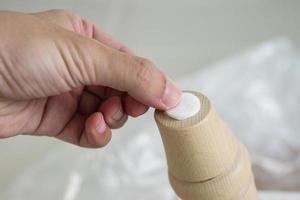 Man sticking floor care pad at sofa leg photo