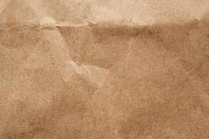 Brown crumpled paper recycled kraft sheet texture background photo