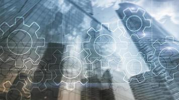 Double exposure gears mechanism on blurred background. Business and industrial process automation concept photo