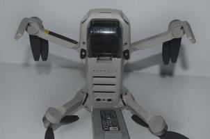 BLITAR, INDONESIA - October 3rd 2022 Drone DJI Mini 2 bottom view with 2 sensors and slim body isolated with white background photo