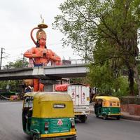 New Delhi, India - June 21, 2022 - Big statue of Lord Hanuman near the delhi metro bridge situated near Karol Bagh, Delhi, India, Lord Hanuman big statue touching sky photo