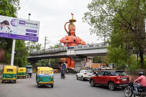 New Delhi, India - June 21, 2022 - Big statue of Lord Hanuman near the delhi metro bridge situated near Karol Bagh, Delhi, India, Lord Hanuman big statue touching sky photo