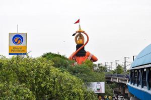 New Delhi, India - June 21, 2022 - Big statue of Lord Hanuman near the delhi metro bridge situated near Karol Bagh, Delhi, India, Lord Hanuman big statue touching sky photo