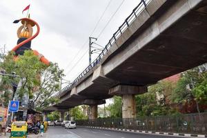 New Delhi, India - June 21, 2022 - Big statue of Lord Hanuman near the delhi metro bridge situated near Karol Bagh, Delhi, India, Lord Hanuman big statue touching sky photo