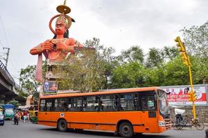 New Delhi, India - June 21, 2022 - Big statue of Lord Hanuman near the delhi metro bridge situated near Karol Bagh, Delhi, India, Lord Hanuman big statue touching sky photo