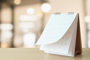 desk calendar on table with blurred bokeh background appointment and business meeting concept photo