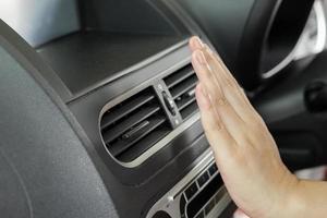 hand checking air conditioner system inside the car photo