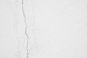 cracked concrete on white wall texture background photo