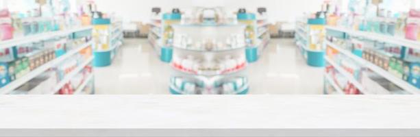 Empty white marble counter top with blur pharmacy drugstore shelves background photo